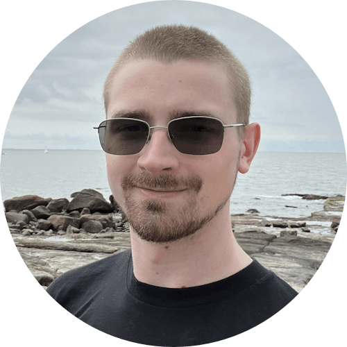 AJ Cutshall beach selfie wearing sunglasses and black shirt